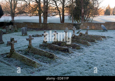 A row of graves in St. Andrew`s churchyard, Toddington, Gloucestershire, England, UK Stock Photo